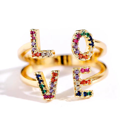 Women gold color "LOVE" stackable ring with multicolor gemstones in punk rock style.